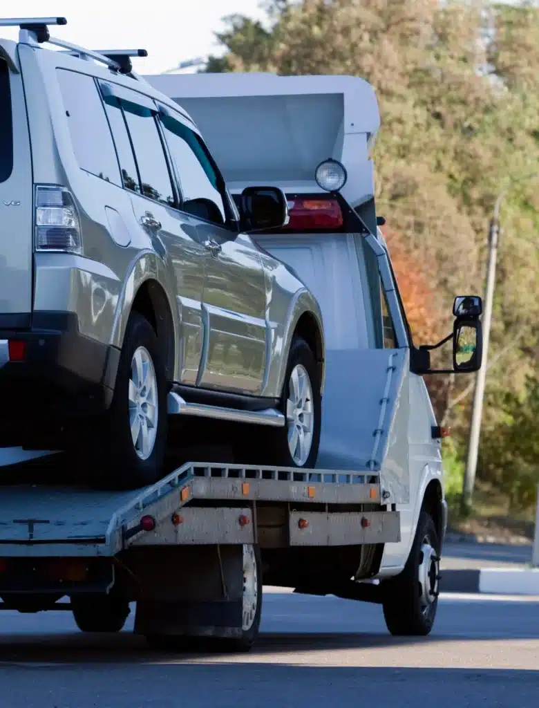 véhicule immobilisé en cours de remorquage par une dépanneuse, démontrant une assistance automobile efficace